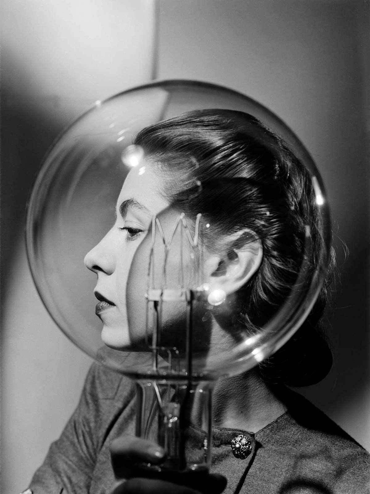 Lee Miller, Model with lightbulb, Vogue Studio, London, England c. 1943 - © Lee Miller Archives